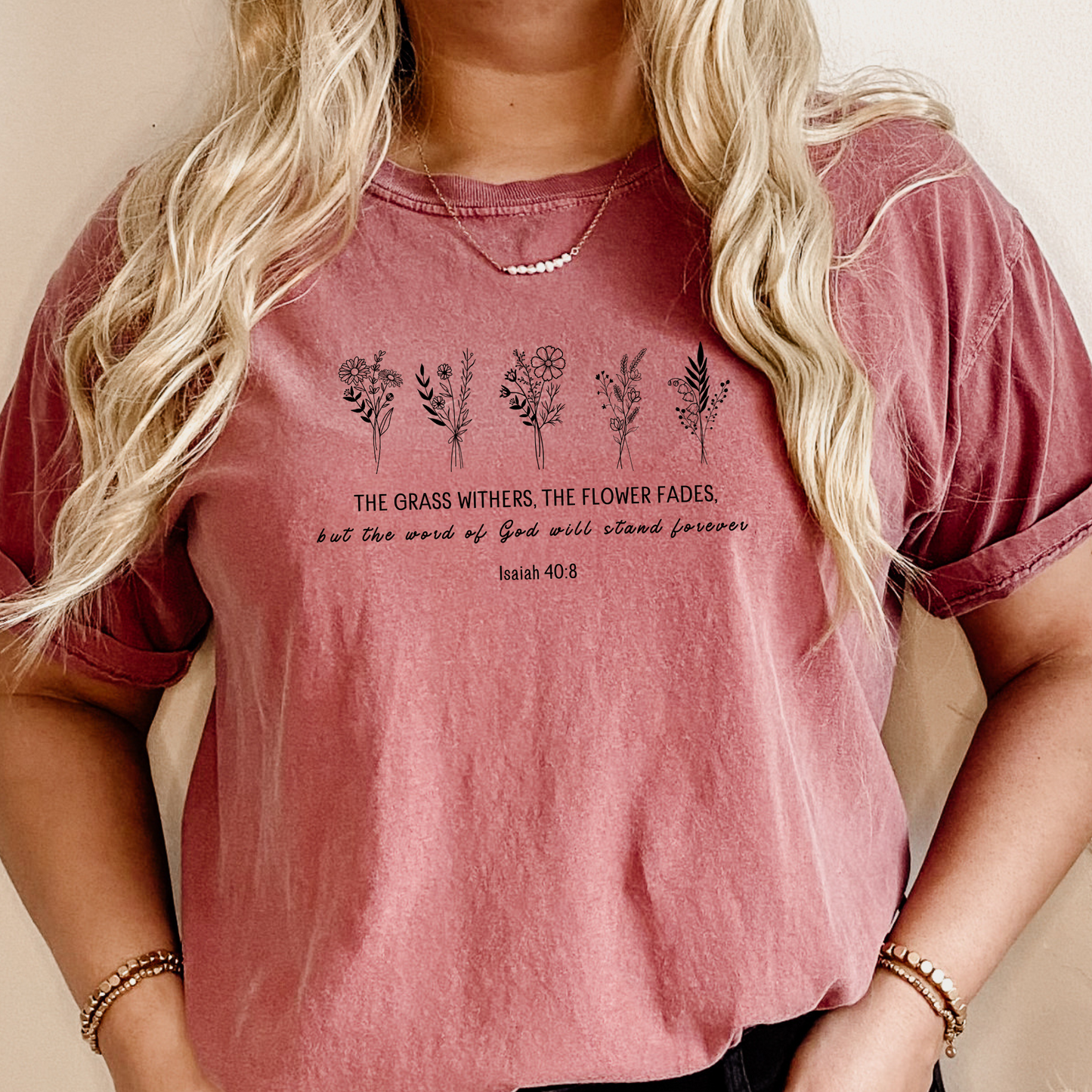 Woman's Christian T-shirt featuring bible verse Isaiah 40:8 the grass withers, the flower fads but the word of the Lord will stand forever.