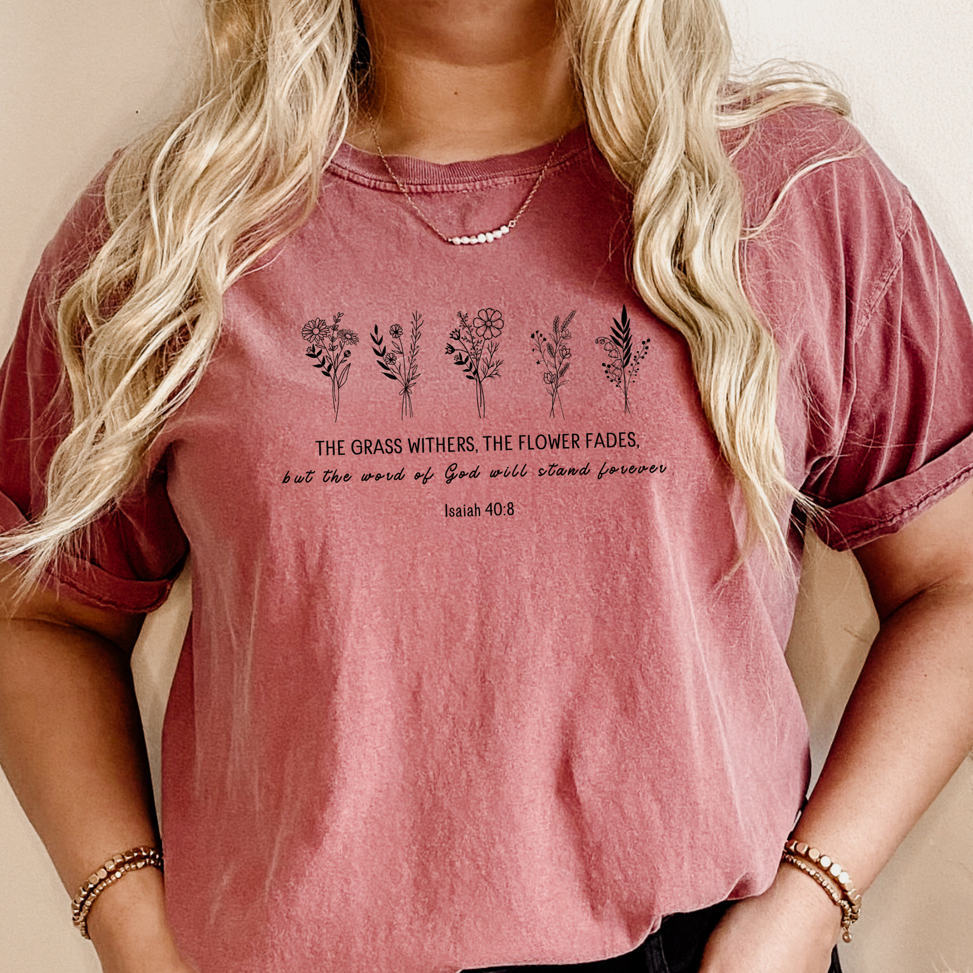 Woman's Christian T-shirt featuring bible verse Isaiah 40:8 the grass withers, the flower fads but the word of the Lord will stand forever.
