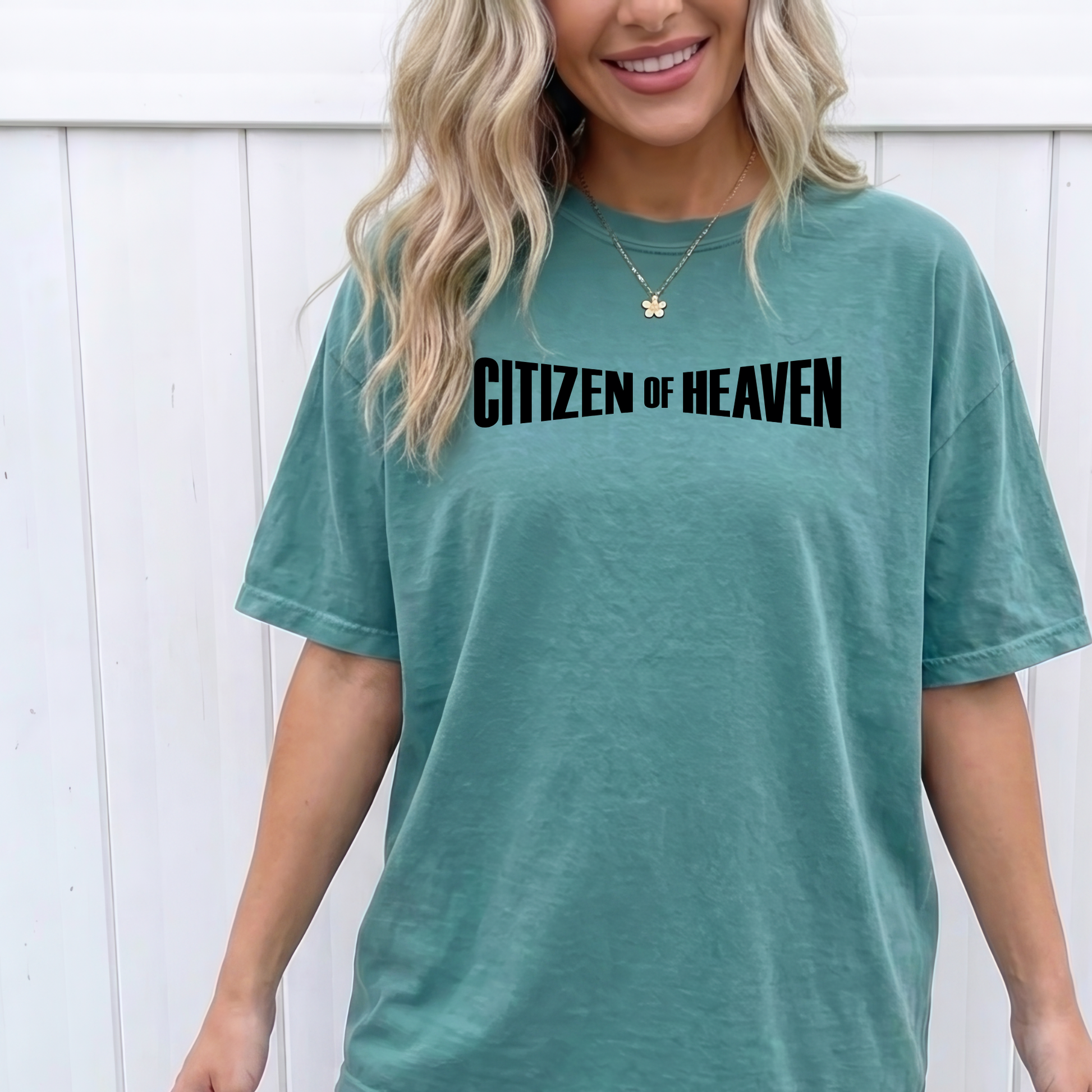 Woman wearing a Citizen of Heaven Christian graphic t-shirt inspired by Philippians 3:20 from a faith based boutique.